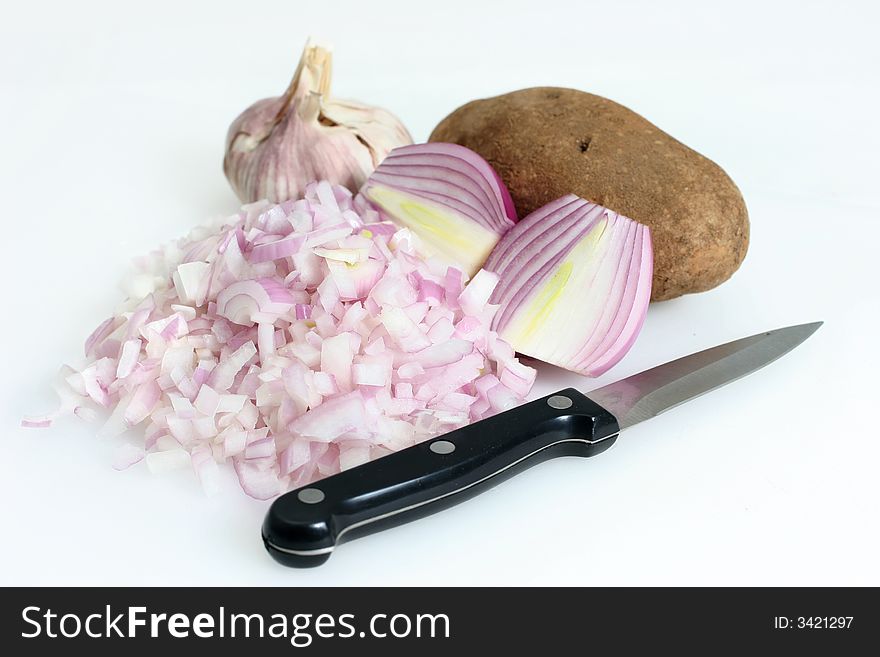 Red onions sliced and diced, garlic and potato for cooking. Red onions sliced and diced, garlic and potato for cooking
