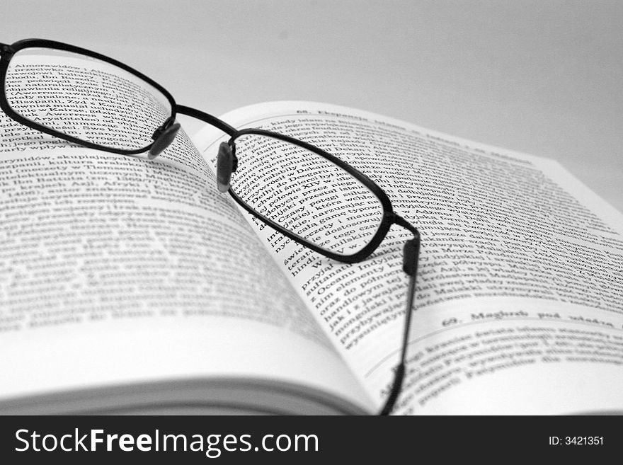 History book with glasses in black and white. History book with glasses in black and white.