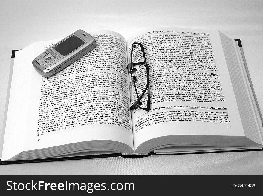 History book with glasses and mobile phone. History book with glasses and mobile phone.
