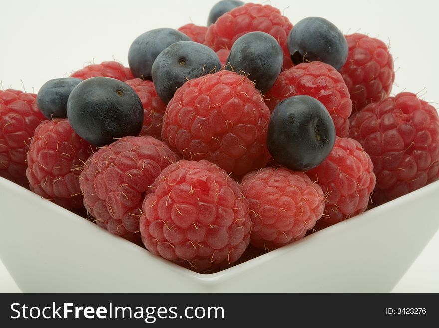 Raspberry and blueberry dessert on a white background