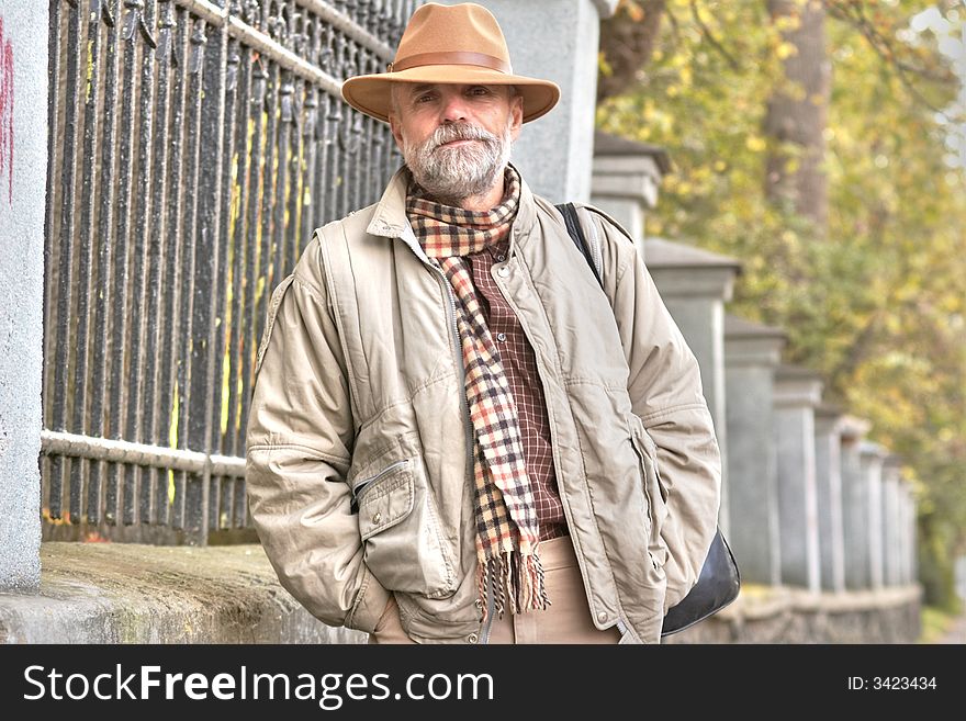 Grey-bearded man in a hat having a walk. Grey-bearded man in a hat having a walk