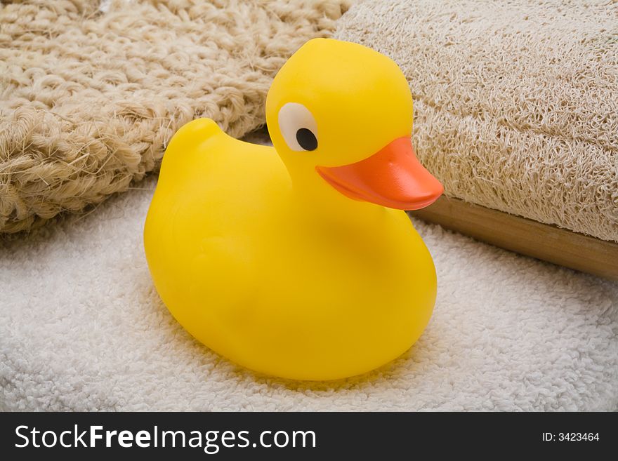 Yellow rubber duck on bathing towel