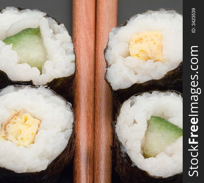 Japanese sushi with chopsticks on a black plate