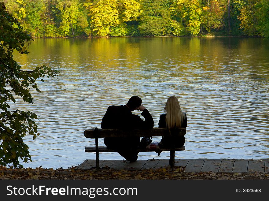 Man and the woman on a background of lake. Man and the woman on a background of lake