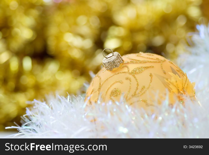 Golden christmas ball on abstract background