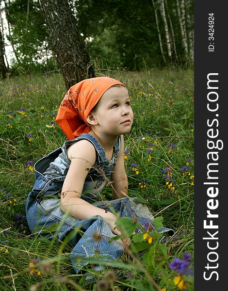 Little girl sit on grass in forest. Little girl sit on grass in forest
