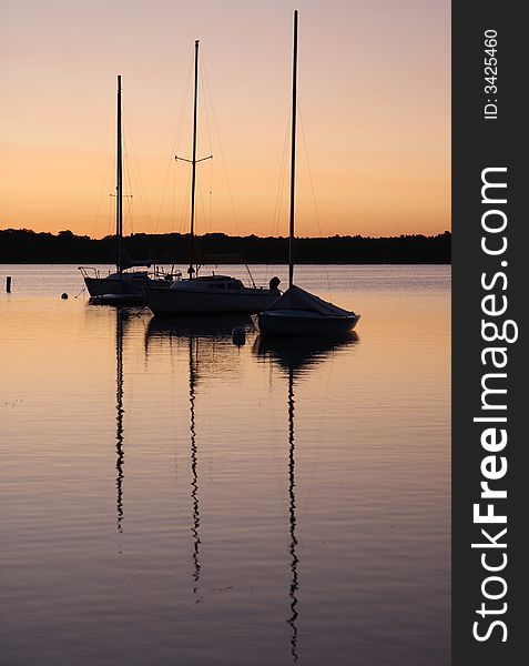 Sunrise on the White Bear Lake - three boats with reflections