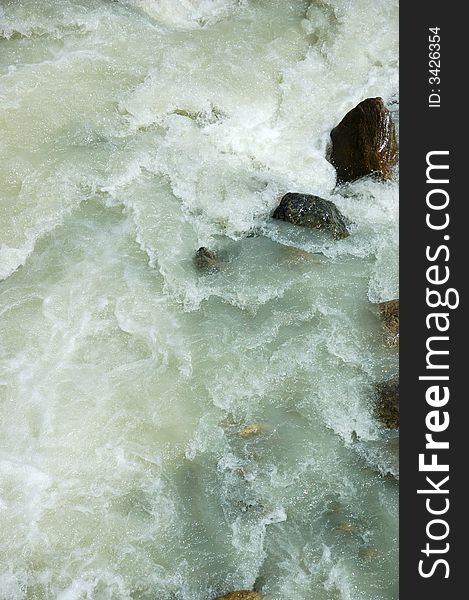 River rapid shot taken with fast shutter speed; vertical orientation. River rapid shot taken with fast shutter speed; vertical orientation