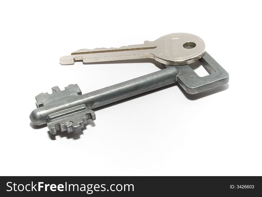 Metal keys from an entrance door of an apartment. The image is isolated.