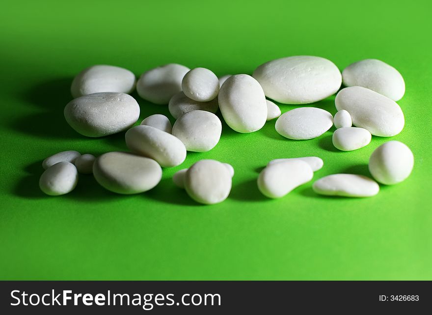 White stones of quartz on a green surface