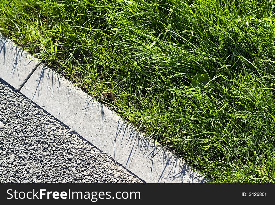 Grean  lawn and asphalt pavement. Grean  lawn and asphalt pavement