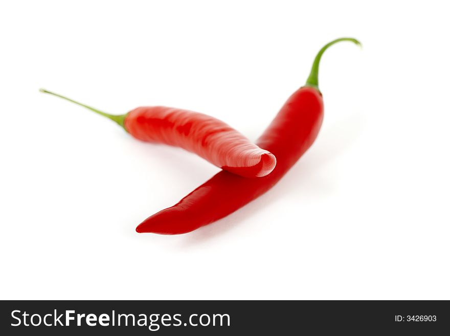 Red chili peppers isolated on white. Red chili peppers isolated on white
