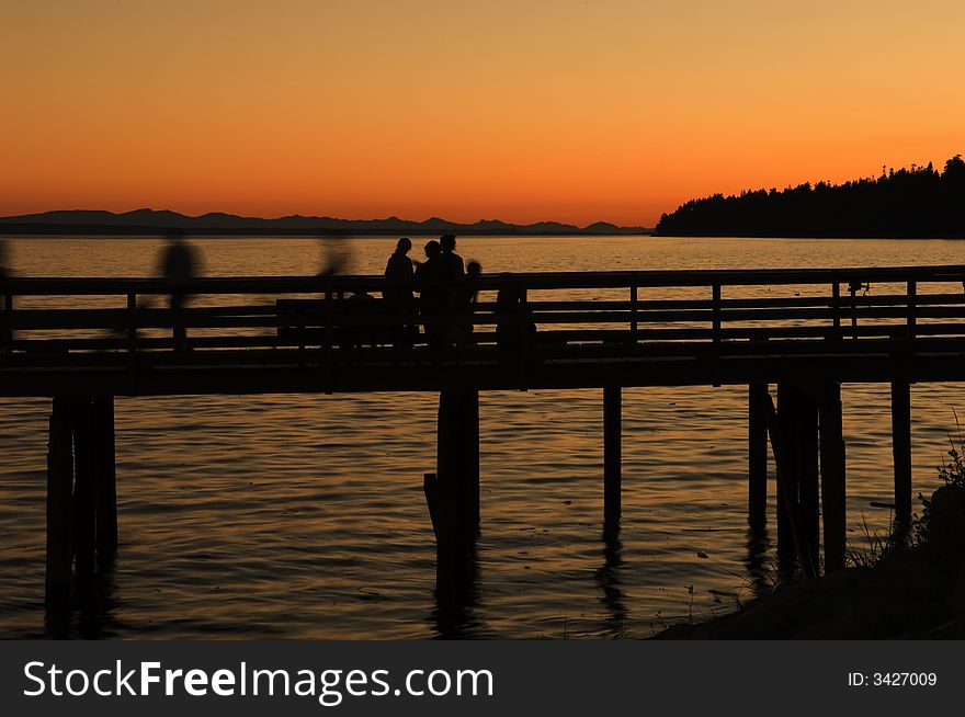 The sun sets over the pier at whiterock beach bc canada. The sun sets over the pier at whiterock beach bc canada