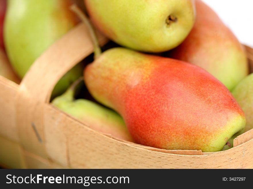 Ripe fresh pears in a basket, background