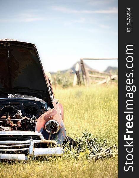 Abandoned car in field