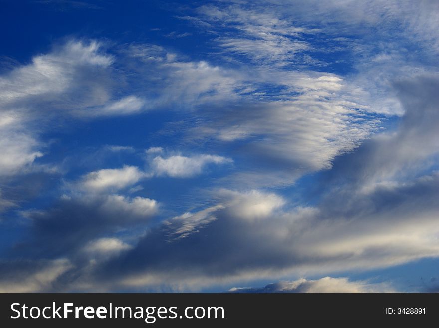 A dark blue sky with clouds on a autumn day. A dark blue sky with clouds on a autumn day.