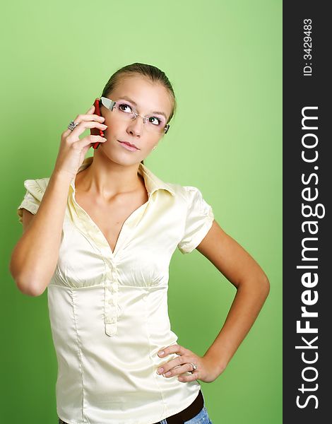 Business portrait of a young and successful woman is calling with a mobilephone. Business portrait of a young and successful woman is calling with a mobilephone