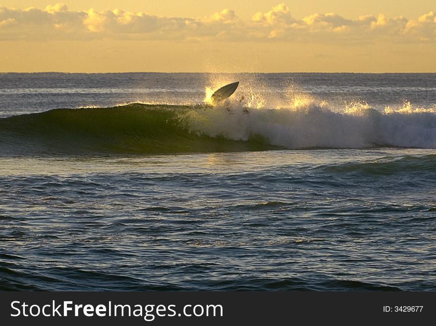 Sunrise surfer wipeout