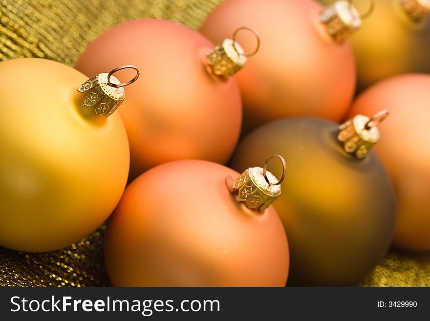 Line up of various golden christmas baubles