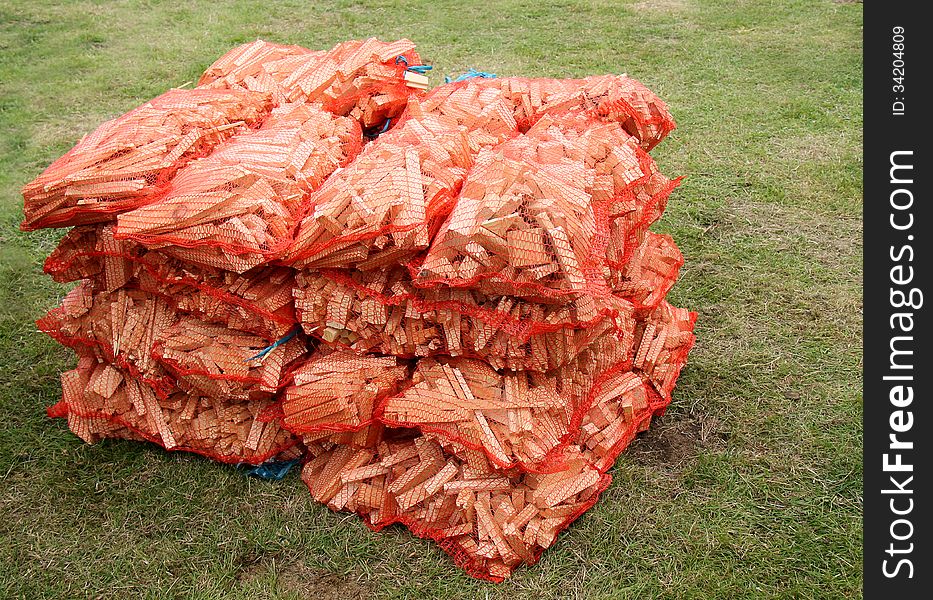 A Stack of Net Sacks Containing Firewood Sticks.