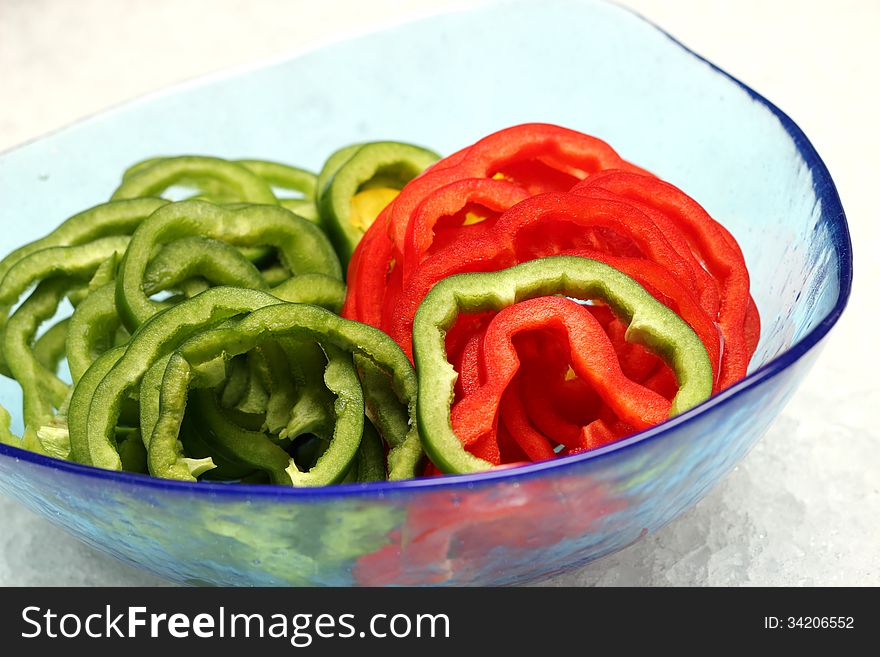 Fresh green and red bell pepper in glass bolwe