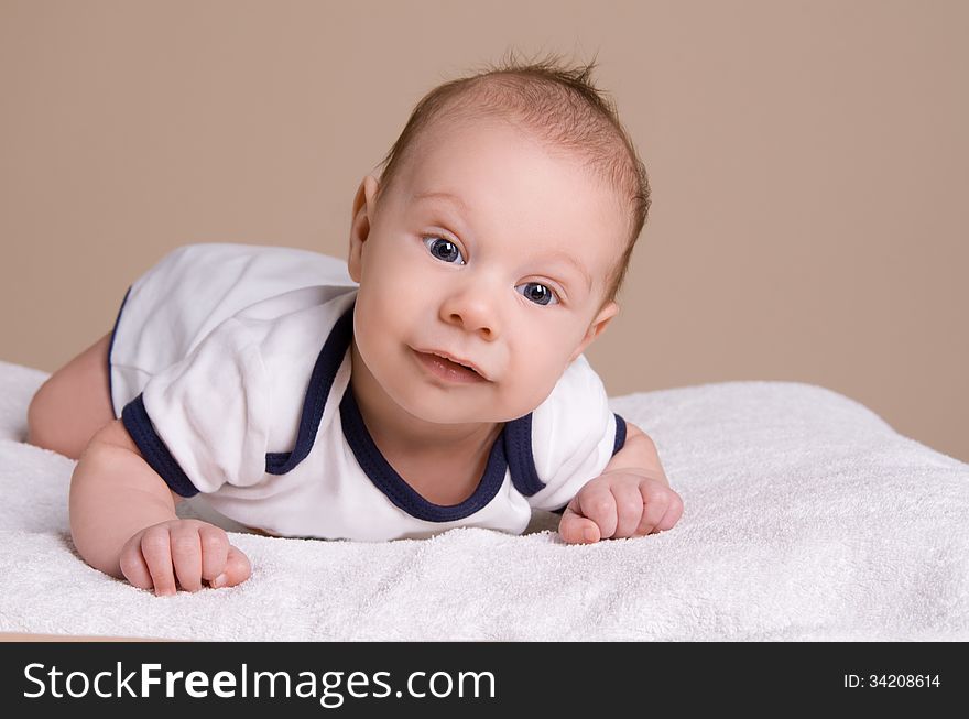 Cute smiling baby on white towel