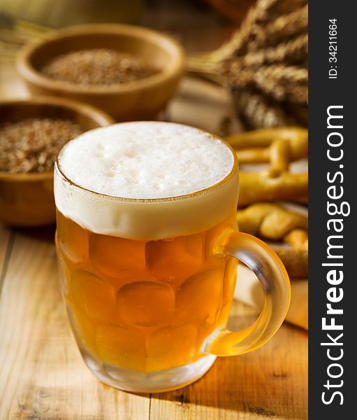 Mug of beer on wooden table