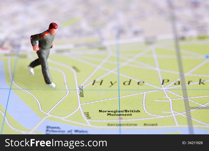 Miniature man figure over city map. Miniature man figure over city map