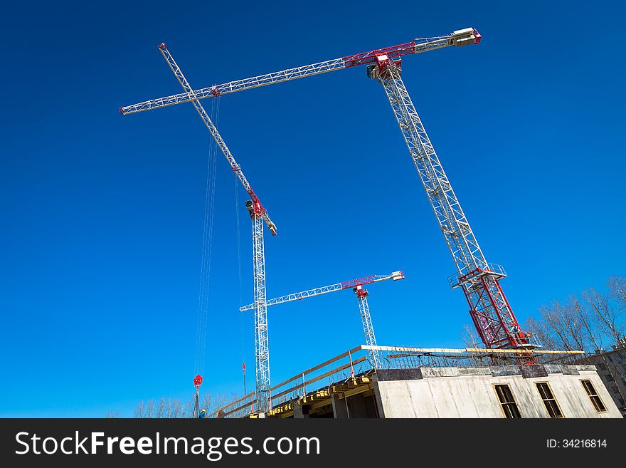 Construction site with cranes on sky background