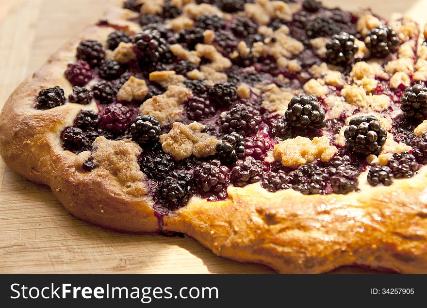 Fresh baked flat bread topped with blackberries and brown sugar. Fresh baked flat bread topped with blackberries and brown sugar