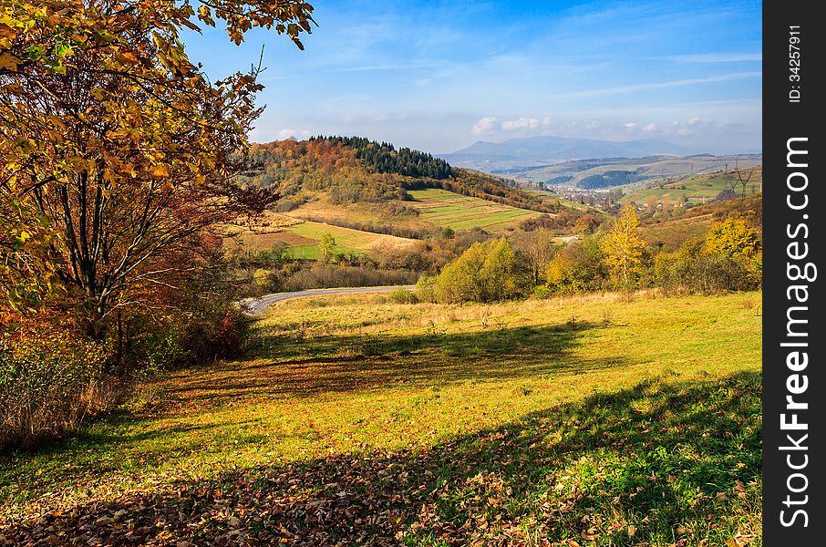 Autumn Landscape With Meadow And Village  In Mountains