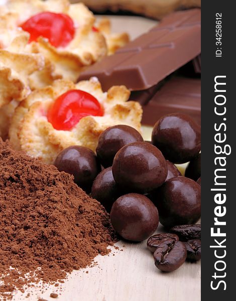 Pastries and chocolate bars in the foreground with selective focus. Pastries and chocolate bars in the foreground with selective focus