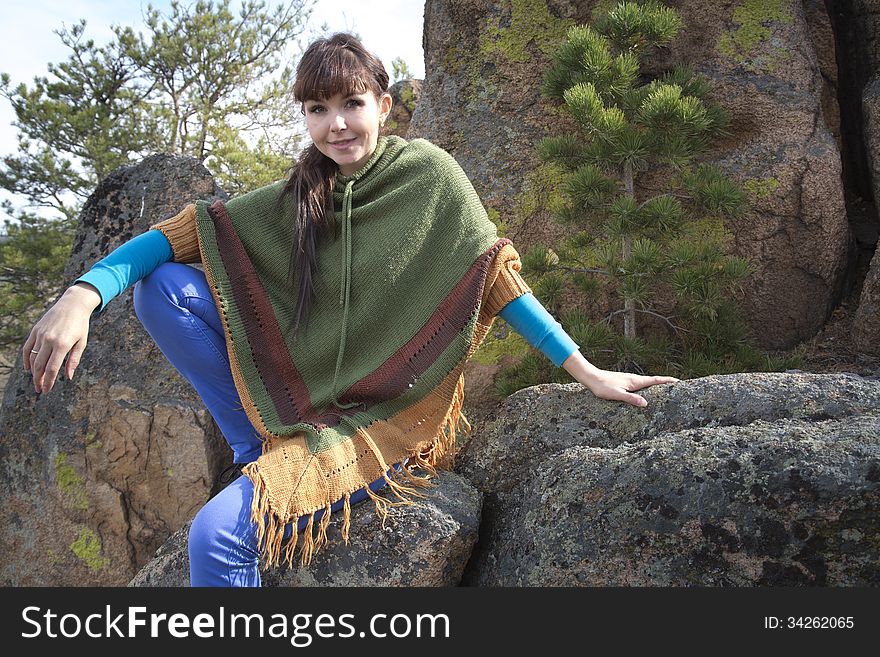 Beautiful woman posing on a rock in the mountains with lake. Beautiful woman posing on a rock in the mountains with lake