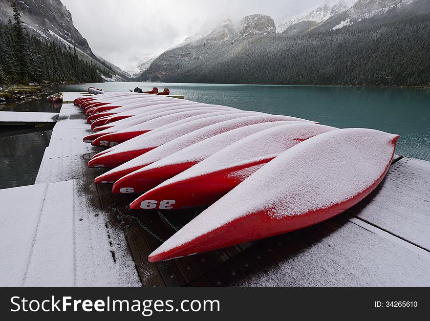 red Boats piled on the deck near Lake Louise with fresh snow, Banff National Park, Alberta, Canada. red Boats piled on the deck near Lake Louise with fresh snow, Banff National Park, Alberta, Canada.