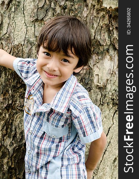 Little Boy Smiling In The Park Portrait