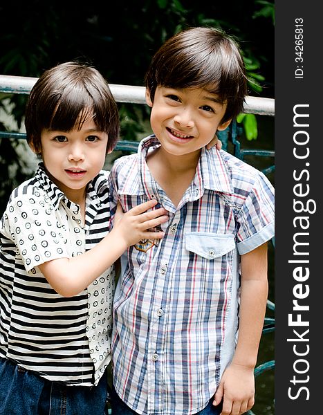 Little sibling boy smiling together outdoor