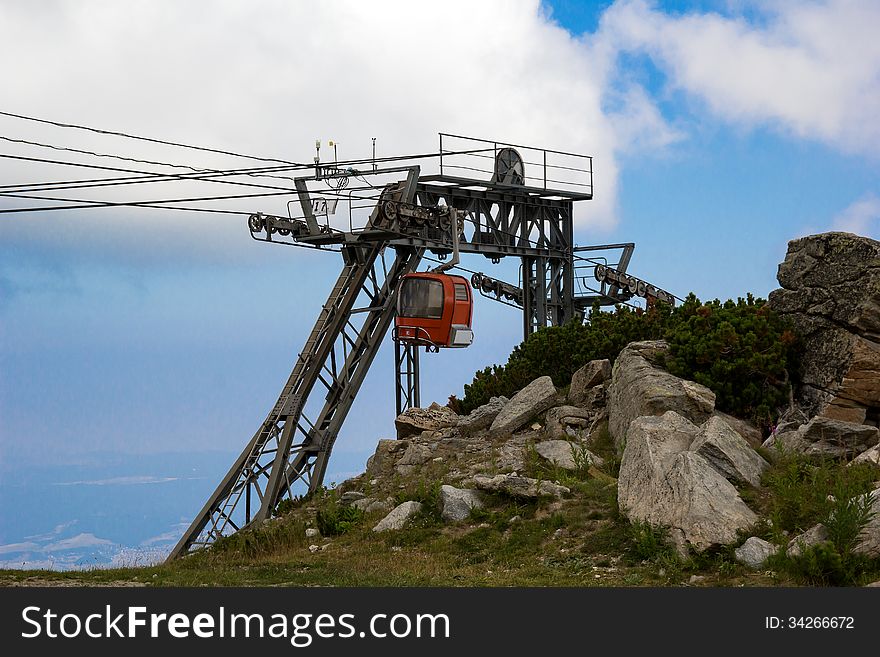 The cable car station is located in the mountains. The cable car station is located in the mountains