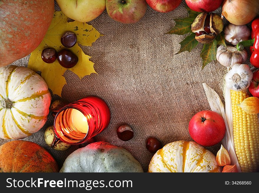 Thanksgiving vegetables, fruits border. Pumpkins, corn, apple on a natural background frame. Thanksgiving vegetables, fruits border. Pumpkins, corn, apple on a natural background frame