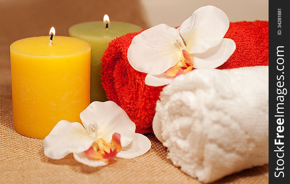 Two towels with orchid and candles