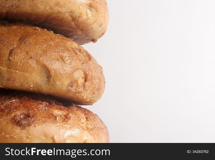 Three stacked sweet tasty cinnamon bagel closeup. Three stacked sweet tasty cinnamon bagel closeup