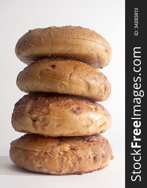 Four stacked sweet tasty cinnamon bagel closeup. Four stacked sweet tasty cinnamon bagel closeup