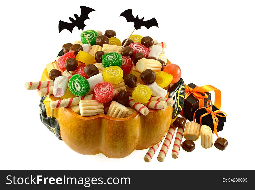 Pumpkin dish full of sweets and gifts isolated. Pumpkin dish full of sweets and gifts isolated