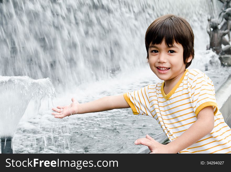 Little Boy Playing Water Fountain