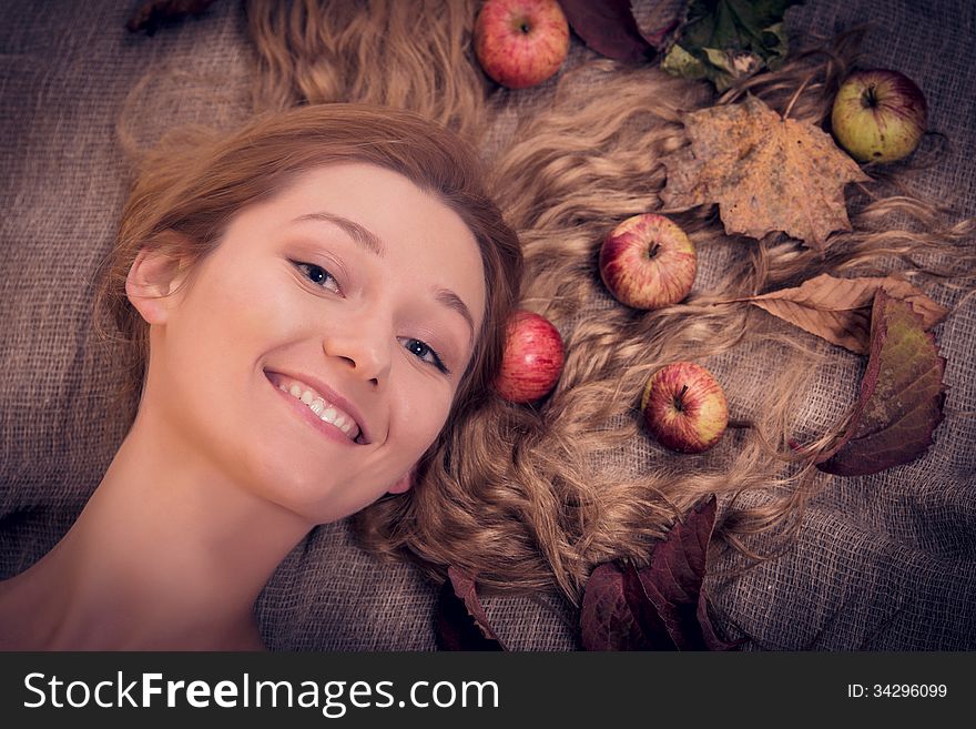 Autumn Beauty Woman Portrait With Fruits And Leaves In Her Golden Hair