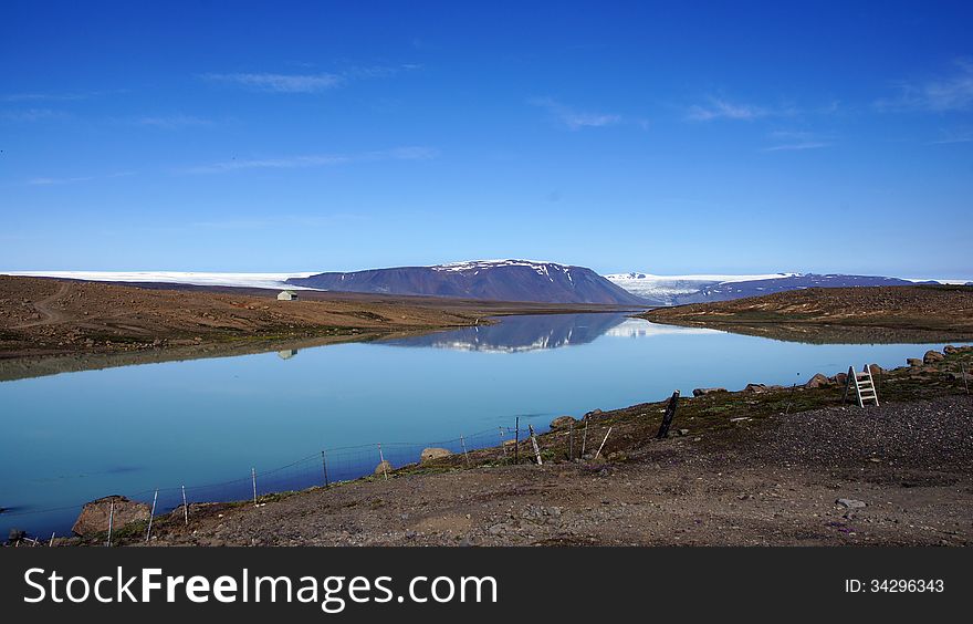 Glacier lake Hvitarvatn with in reflection the LangjÃ¶kull glacier on a great summer day in Iceland. Glacier lake Hvitarvatn with in reflection the LangjÃ¶kull glacier on a great summer day in Iceland.
