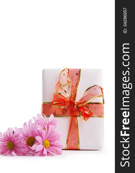 Gift box with red ribbon and pink dasies