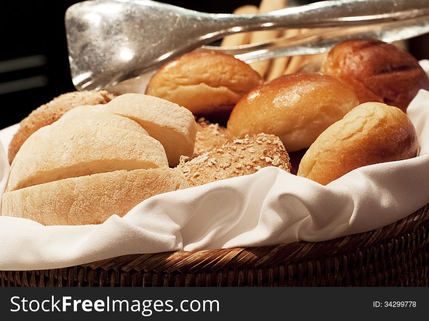 A basket containing assorted breads. A basket containing assorted breads