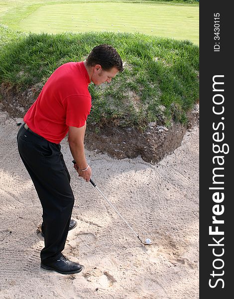 Young golfer preparing for a bunker shot. Young golfer preparing for a bunker shot