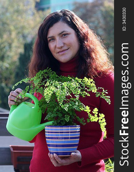 Woman plant care adiantum raddianuma