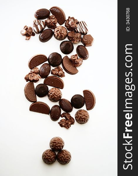 A question mark compiled of chocolate pralines. A question mark compiled of chocolate pralines.